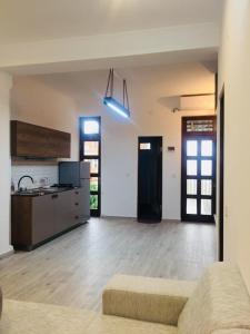 a living room with a couch and a kitchen at Apartment Soho Tabidze in Kutaisi