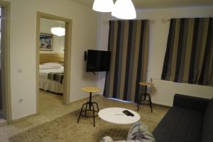 a living room with a couch and a bed at Marina Sahil Hotel in Çeşme