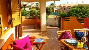 a patio with a table and chairs on a balcony at Deluxe garden flat near Terra-M&iacute;tica in Benidorm