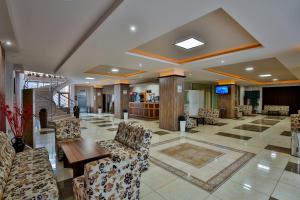 a lobby with chairs and a table in a building at Kamchia Park Hotel - All Inclusive in Golden Sands