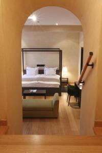 Posteľ alebo postele v izbe v ubytovaní Heritage Hotel Kukuriku