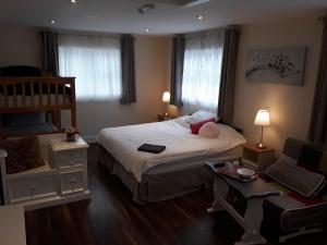 a small bedroom with a bed and a chair at Ridge-Rock Accommodation in Carrick on Shannon
