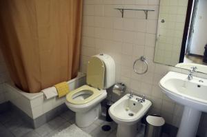 a bathroom with a toilet and a sink at Casa Do Carvalho in Viatodos