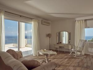 a living room with a couch and a table at Golden July Luxury Villa in Akrotiri