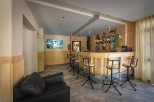 a living room with a bar with stools at Dimitris Paritsa Hotel in Kos Town