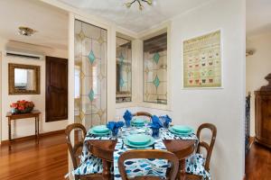 a dining room with a table with blue and white plates at Venice Heaven Apartments San Marco 1 & 2, the Elegant Residence a stone s throw from St Mark s Square in Venice