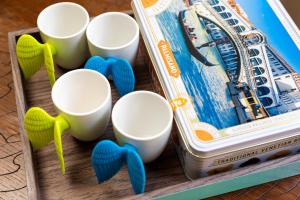 a wooden box with cups and a musical instrument at Venice Heaven Apartments San Marco 1 & 2, the Elegant Residence a stone s throw from St Mark s Square in Venice
