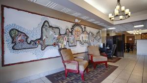 a lobby with chairs and a large mural on the wall at Econo Lodge in Waynesboro
