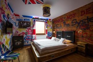 a bedroom with a bed with graffiti on the walls at Retro hotel Garage in Ostrava