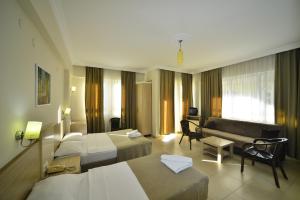 a hotel room with a bed and a couch at Prince Apart & Hotel in Alanya