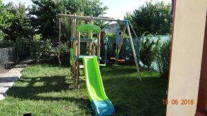 a playground with a slide in the grass at Maria-Antonia in Mangalia