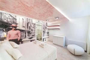 a man standing in a bedroom with a bed at Ca' de la Fonte - WENICE Deep Culture in Venice