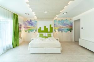 a bedroom with a bed and a painting on the wall at Ca' de la Fonte - WENICE Deep Culture in Venice