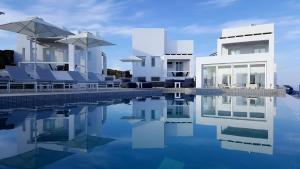 a villa with a swimming pool in front of it at Lemon Tree Houses in Áno Meriá