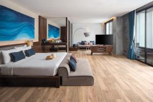 a bedroom with a large bed and a living room at Idyllic Concept Resort in Ko Lipe