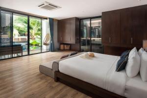 a bedroom with a large bed and a large window at Idyllic Concept Resort in Ko Lipe