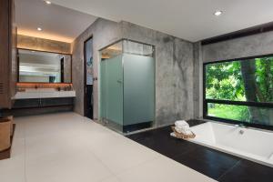 a bathroom with a bath tub and a large window at Idyllic Concept Resort in Ko Lipe +37 photos