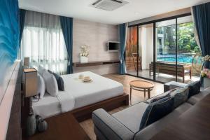 a bedroom with a bed and a couch and a tv at Idyllic Concept Resort in Ko Lipe
