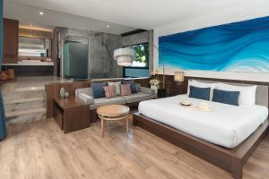 a bedroom with a large bed and a couch at Idyllic Concept Resort in Ko Lipe