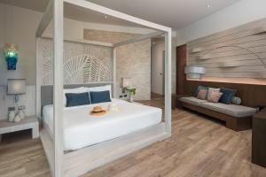a bedroom with a large white bed and a couch at Idyllic Concept Resort in Ko Lipe