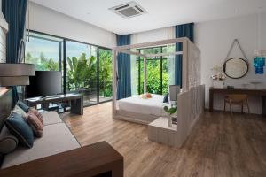 a bedroom with a bed and a desk in a room at Idyllic Concept Resort in Ko Lipe