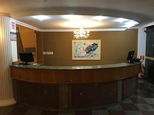 a lobby with a reception desk in a building at Hotel Mello in Cascavel