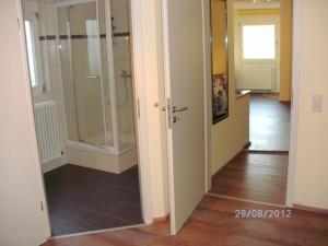 a bathroom with a shower and a glass door at Hotel am Hindenburgplatz in Appenweier