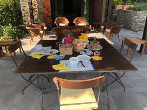 a wooden table with food on top of it at Villa le Noci in Bettola