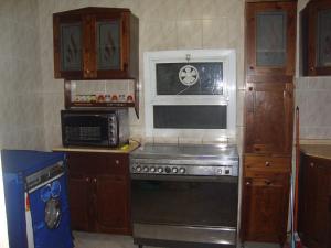 a kitchen with a stove and a microwave at Luxury Villa Panorama Beach in El Alamein