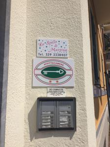 un cartello sul lato di un edificio con una macchina di Le Stelle di Martina- Affittacamere - a La Spezia