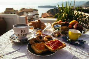 a plate of breakfast food on a table with a cup of coffee at B&B Vistamar in San Nicola Arcella