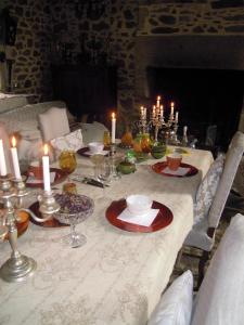 a table with candles and plates and glasses on it at Domaine De La Bastille in Saint Malo