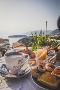 a table with a cup of coffee and a plate of food at B&B Vistamar in San Nicola Arcella