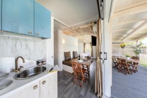 a kitchen and dining area of a tiny house at Il Borgo delle Arti in Verbania