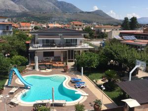 a large swimming pool in front of a house at Boccy Brothers in Formia