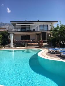 a swimming pool in front of a house at Boccy Brothers in Formia