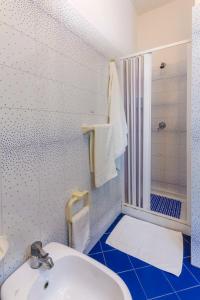 a bathroom with a white sink and a shower at Residence I Pianeti in San Vito lo Capo