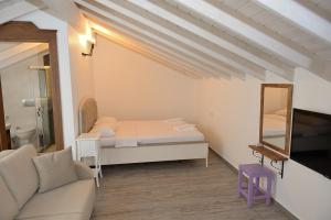 a small room with a bed and a mirror at Brothers Çeşme Boutique Hotel in Cesme