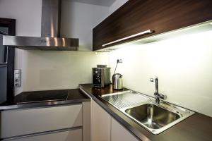 a kitchen with a sink and a microwave at Above the historical roofs in Bratislava