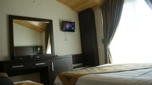 TV a/nebo společenská místnost v ubytování Palmira Hotel