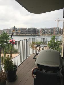 a balcony with a table and a view of the water at Home Stay Marmormolen (Marmorvej) in Copenhagen