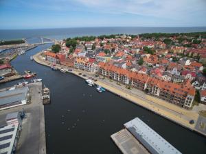 an aerial view of a city with a river and buildings at Apartament w Centrum in Ustka