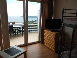 a room with a balcony with a view of the ocean at Family Hotel Casablanca Green in Varna City