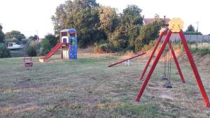 a playground with two play equipment in a field at Apartment Danica in Valtura