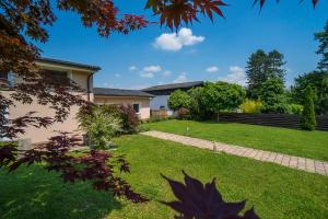 a garden with a house and a lawn at Guest House Pri Gondoli in Maribor