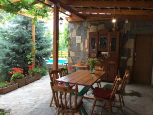 a wooden table and chairs on a patio at Green Stone Boutique Hotel in Yeghegnadzor
