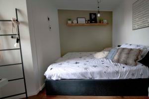 een slaapkamer met een bed met witte lakens en kussens bij De Kade in Goes