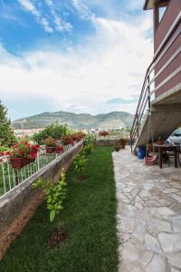 a patio with plants and flowers on the side of a building at Apartment Nijona in Trebinje