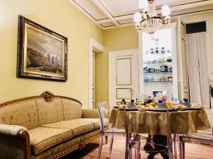 - un salon avec un canapé et une table avec de la nourriture dans l'établissement Dimora Umberto, à Catane
