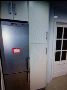 a kitchen with a refrigerator next to a door at VIVIENDA TURISTICA MARANt 2 in El Puerto de Santa María